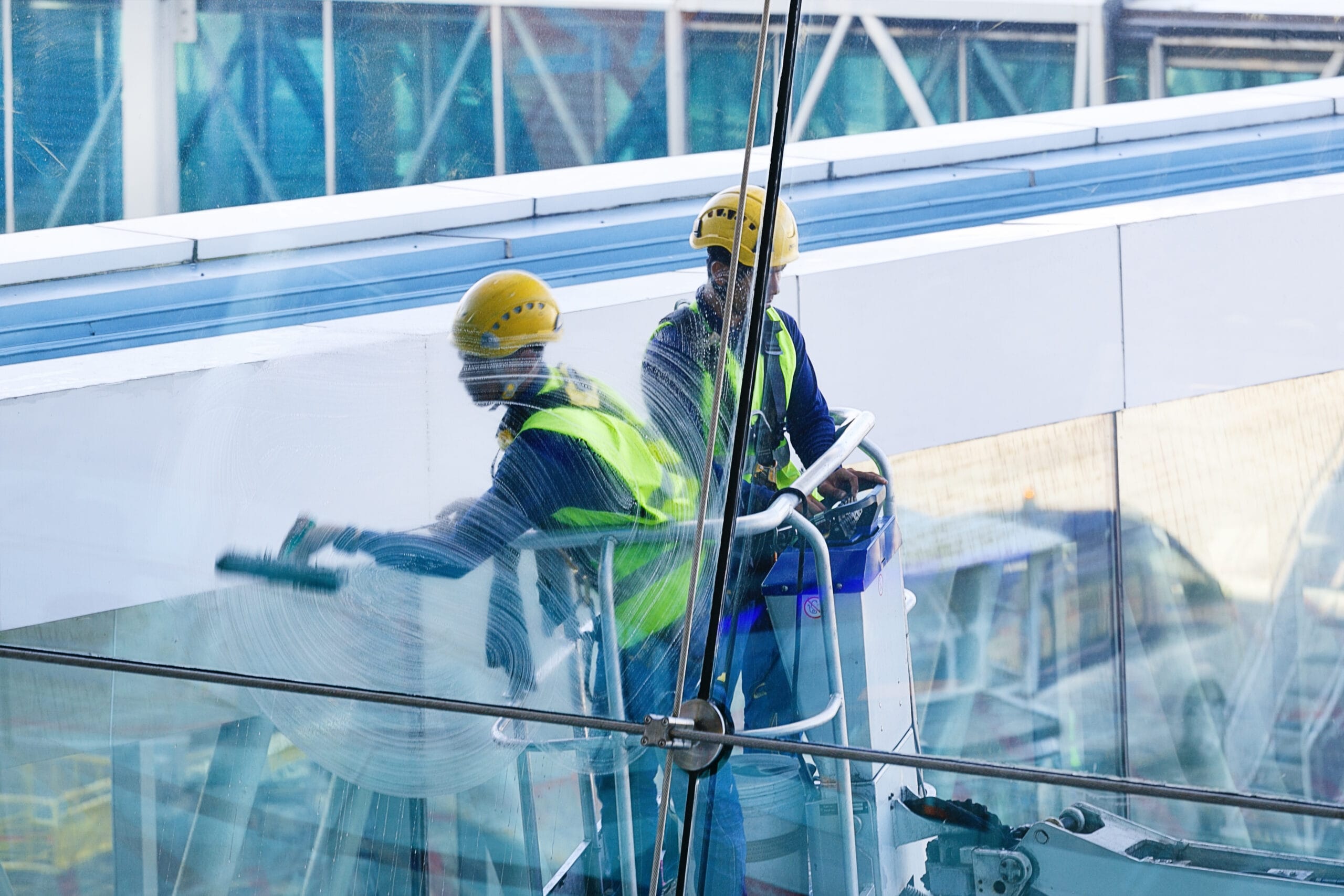 men cleaning windows two workers washing windows modern business building scaled